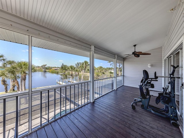 wooden terrace with a water view and ceiling fan