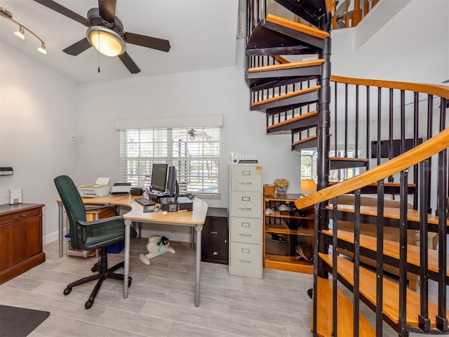 office space with baseboards, ceiling fan, and wood finished floors