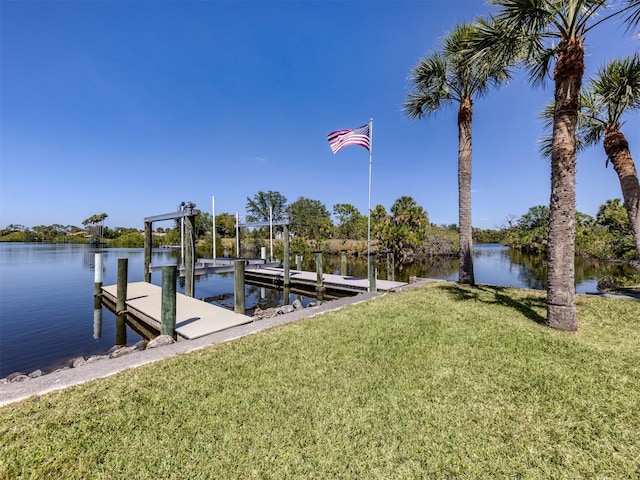view of dock featuring boat lift, a water view, and a lawn
