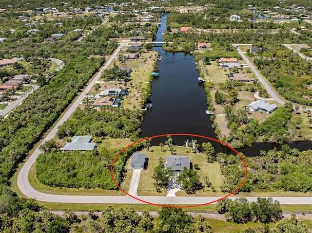 birds eye view of property with a water view and a residential view