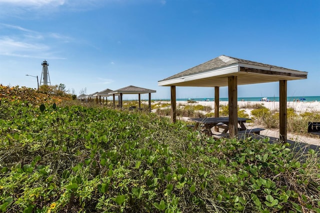 view of home's community featuring a view of the beach, a water view, and a gazebo