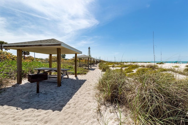 surrounding community with a beach view and a water view