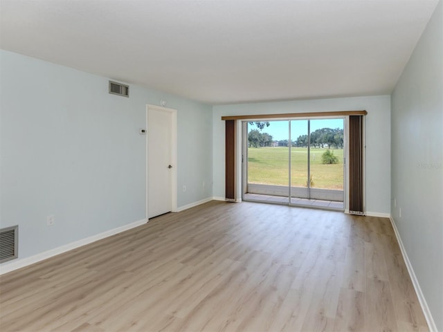 empty room featuring light wood finished floors and baseboards
