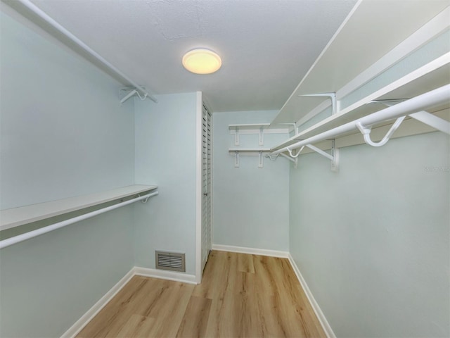 spacious closet featuring light wood-type flooring