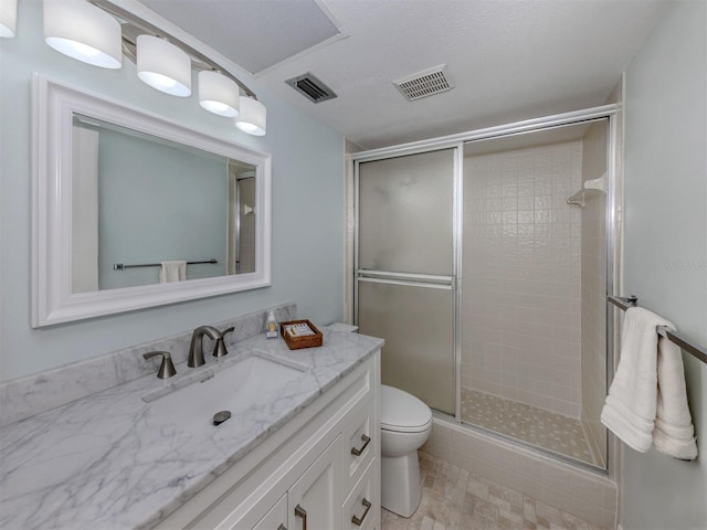 full bathroom with a stall shower, toilet, and vanity