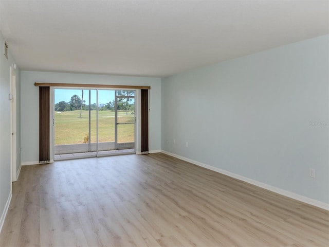 unfurnished room with light wood finished floors and baseboards