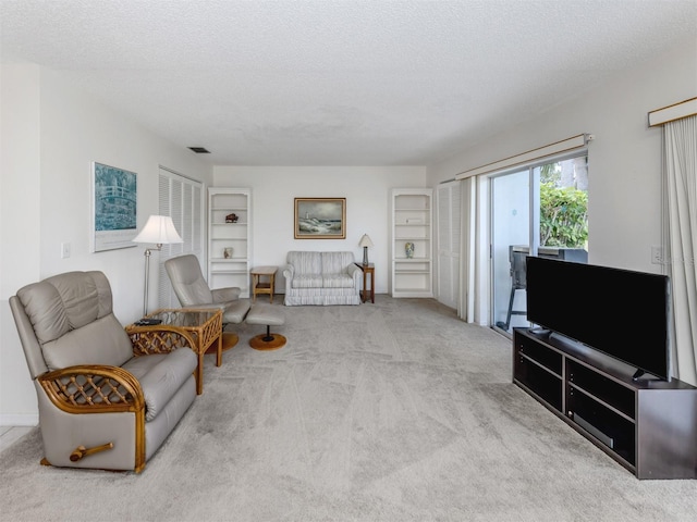 232 Cerromar Way Unit 38, Venice, FL 34293 - living area featuring carpet floors and a textured ceiling