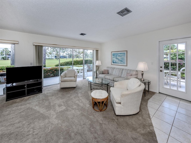 232 Cerromar Way Unit 38, Venice, FL 34293 - tiled living room with a textured ceiling