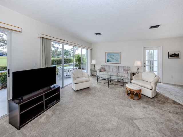 232 Cerromar Way Unit 38, Venice, FL 34293 - carpeted living area featuring plenty of natural light, a textured ceiling, and tile patterned floors