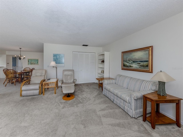 232 Cerromar Way Unit 38, Venice, FL 34293 - carpeted living area featuring a chandelier and a textured ceiling