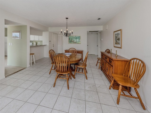 232 Cerromar Way Unit 38, Venice, FL 34293 - dining area featuring a chandelier, light tile patterned flooring, and a textured ceiling