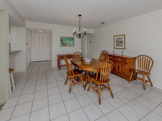 232 Cerromar Way Unit 38, Venice, FL 34293 - dining area featuring a chandelier, light tile patterned floors, a textured ceiling, and baseboards
