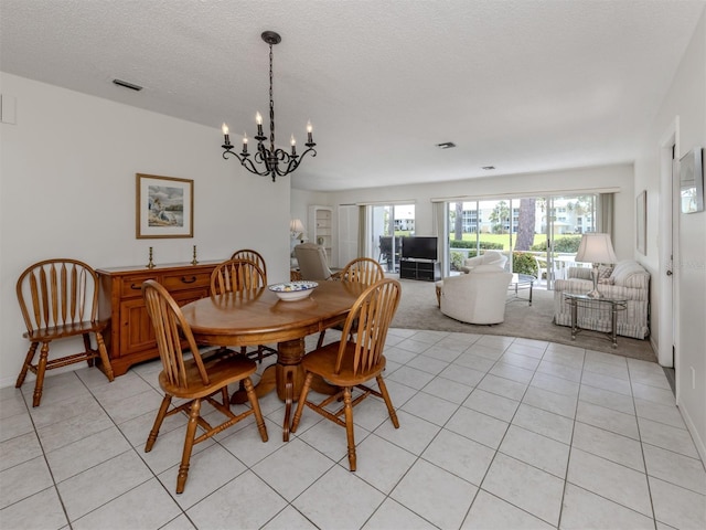 232 Cerromar Way Unit 38, Venice, FL 34293 - dining space featuring a chandelier, light tile patterned floors, and a textured ceiling