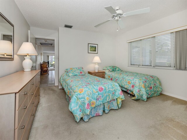 232 Cerromar Way Unit 38, Venice, FL 34293 - bedroom with carpet flooring, a textured ceiling, and a ceiling fan