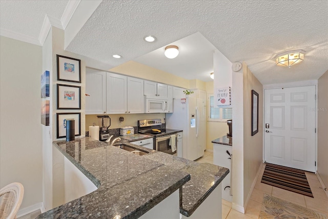 950 Tarpon Center Dr Unit 504, Venice, FL 34285 - kitchen with white appliances, a sink, light tile patterned flooring, a textured ceiling, and dark stone countertops