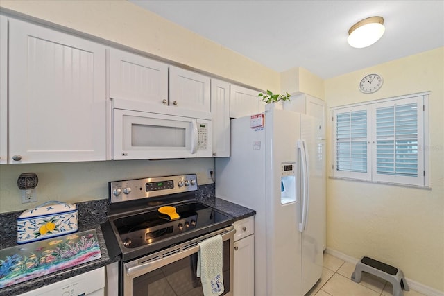 950 Tarpon Center Dr Unit 504, Venice, FL 34285 - kitchen with white appliances, light tile patterned floors, white cabinets, and baseboards