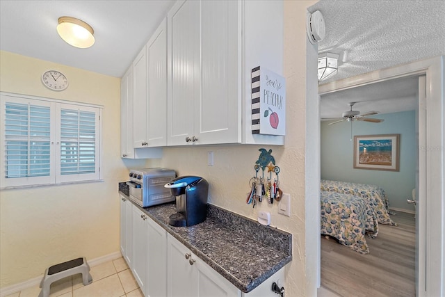 950 Tarpon Center Dr Unit 504, Venice, FL 34285 - bar area featuring baseboards, ceiling fan, a textured ceiling, and light wood-type flooring