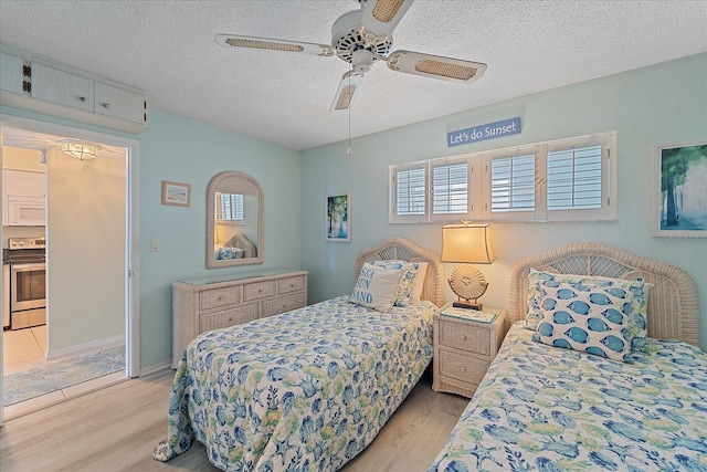 950 Tarpon Center Dr Unit 504, Venice, FL 34285 - bedroom with light wood-type flooring, a textured ceiling, and ceiling fan
