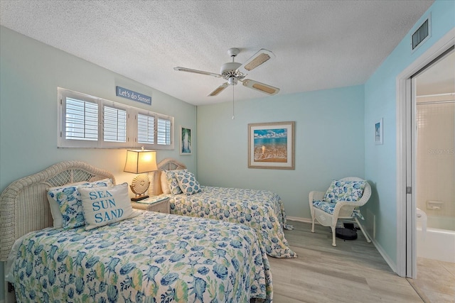 950 Tarpon Center Dr Unit 504, Venice, FL 34285 - bedroom with light wood-style flooring, baseboards, a textured ceiling, and a ceiling fan