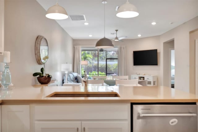 25069 Pearl Lake Cir, Englewood, FL 34223 - kitchen with dishwasher, open floor plan, white cabinets, pendant lighting, and recessed lighting
