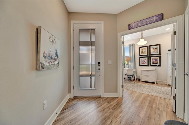 25069 Pearl Lake Cir, Englewood, FL 34223 - doorway featuring light wood-style flooring and baseboards