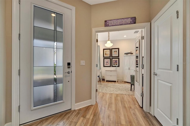 25069 Pearl Lake Cir, Englewood, FL 34223 - doorway with light wood-type flooring and baseboards