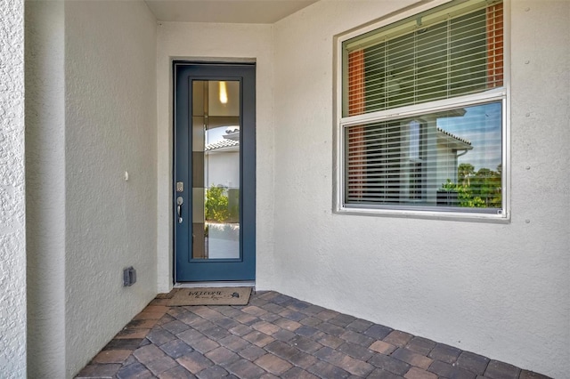 25069 Pearl Lake Cir, Englewood, FL 34223 - doorway to property with stucco siding