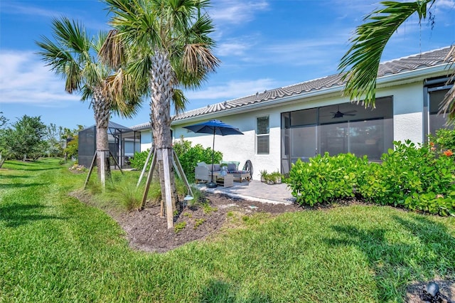 25069 Pearl Lake Cir, Englewood, FL 34223 - view of grassy yard featuring an outdoor living space, a patio, and ceiling fan