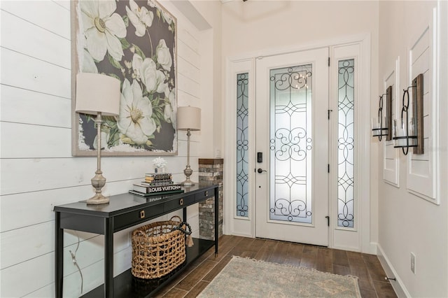 foyer entrance with wood finished floors and baseboards