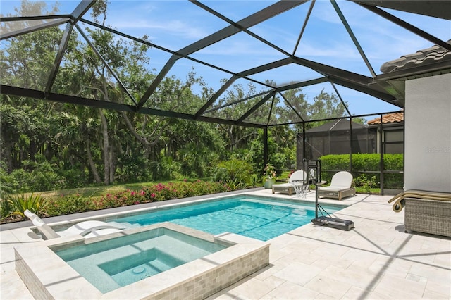 view of swimming pool with a patio area, a pool with connected hot tub, and glass enclosure