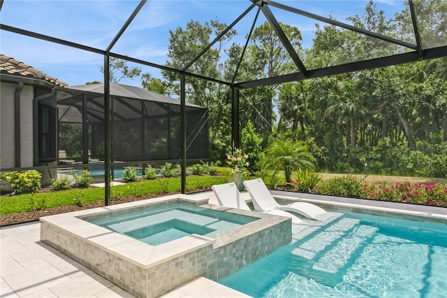 view of swimming pool with a pool with connected hot tub, a lanai, and a patio