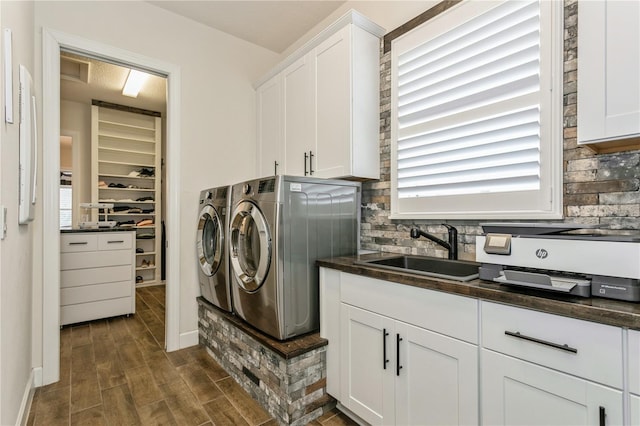 washroom featuring independent washer and dryer, healthy amount of natural light, and dark wood-style floors
