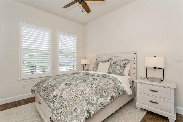 bedroom featuring wood finished floors, baseboards, and ceiling fan