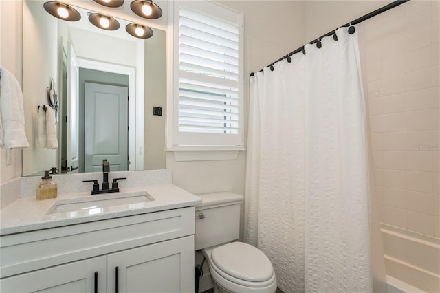 bathroom with toilet, vanity, and shower / bath combo