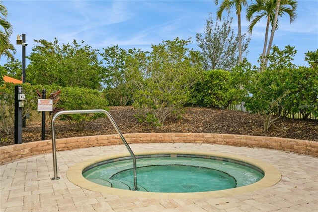 view of pool featuring a hot tub
