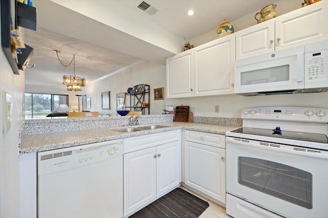 1156 Bird Bay Way Unit 104, Venice, FL 34285 - kitchen featuring white appliances, a sink, a chandelier, white cabinets, and recessed lighting