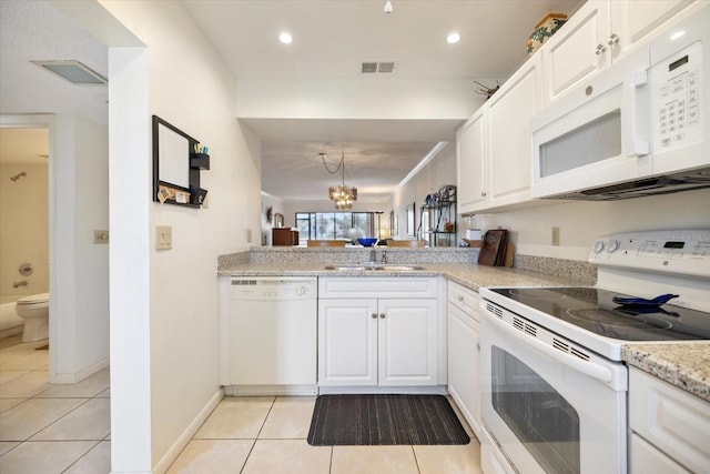 1156 Bird Bay Way Unit 104, Venice, FL 34285 - kitchen with white appliances, light tile patterned flooring, a sink, white cabinetry, and recessed lighting