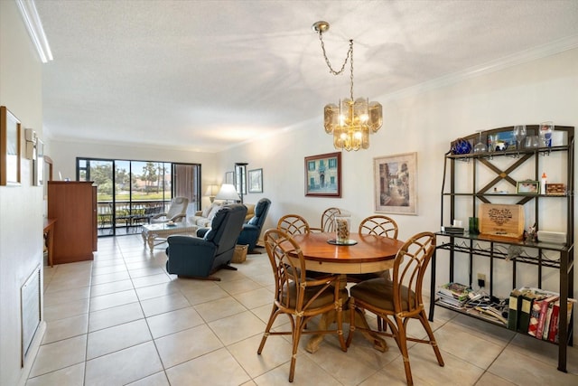 1156 Bird Bay Way Unit 104, Venice, FL 34285 - dining area featuring a chandelier, light tile patterned flooring, crown molding, and a textured ceiling