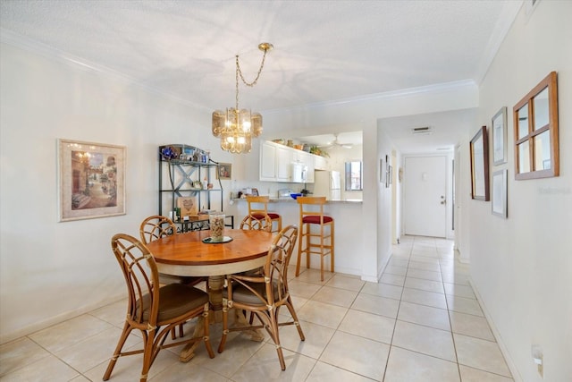 1156 Bird Bay Way Unit 104, Venice, FL 34285 - dining room with light tile patterned flooring, a chandelier, crown molding, and baseboards