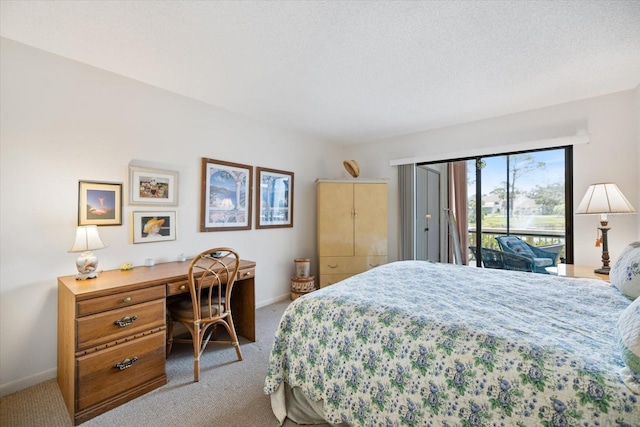 1156 Bird Bay Way Unit 104, Venice, FL 34285 - bedroom with carpet floors, access to exterior, baseboards, and a desk