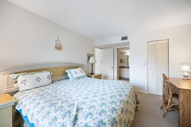 1156 Bird Bay Way Unit 104, Venice, FL 34285 - carpeted bedroom with a closet, baseboards, and connected bathroom