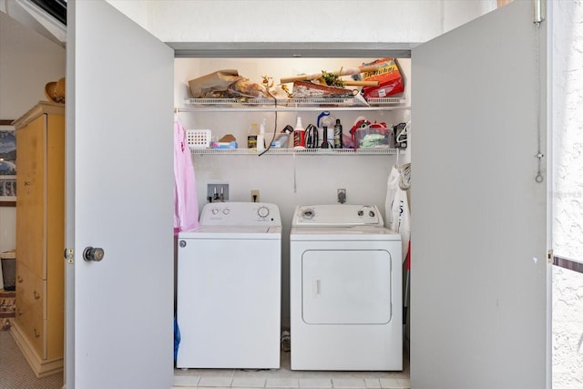 1156 Bird Bay Way Unit 104, Venice, FL 34285 - washroom featuring washing machine and clothes dryer and light tile patterned floors