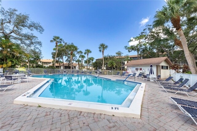 1156 Bird Bay Way Unit 104, Venice, FL 34285 - community pool featuring fence and a patio area