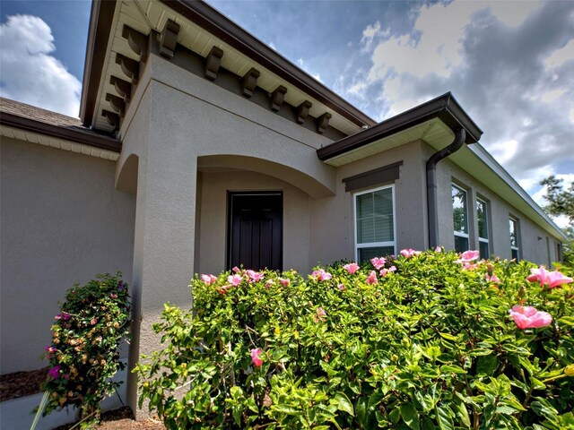 25784 Grayton Ave, Englewood, FL 34223 - doorway to property featuring stucco siding
