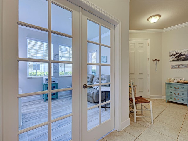 25784 Grayton Ave, Englewood, FL 34223 - entryway with light tile patterned floors, crown molding, baseboards, and french doors
