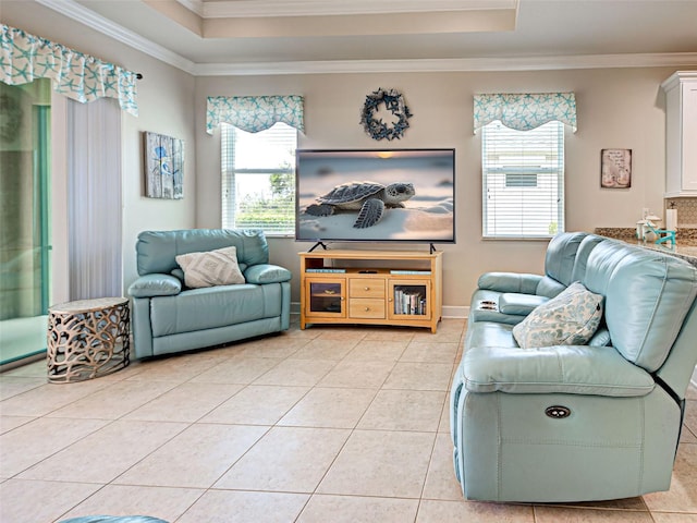 25784 Grayton Ave, Englewood, FL 34223 - living area featuring ornamental molding, a tray ceiling, healthy amount of natural light, light tile patterned floors, and baseboards