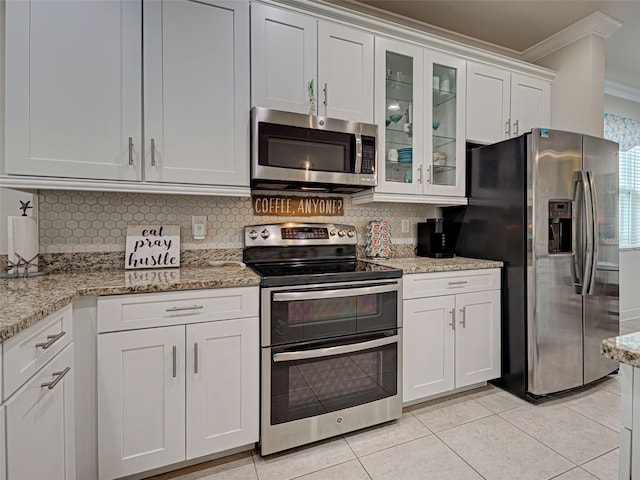 25784 Grayton Ave, Englewood, FL 34223 - kitchen featuring stainless steel appliances, ornamental molding, backsplash, white cabinetry, and glass insert cabinets