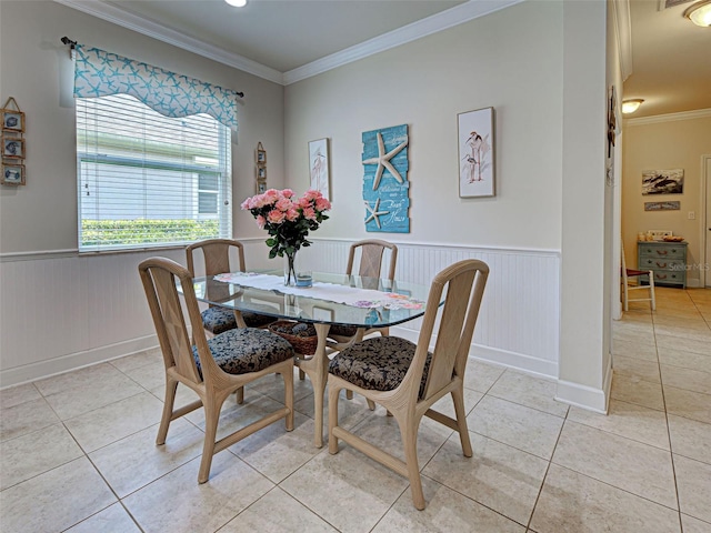 25784 Grayton Ave, Englewood, FL 34223 - dining space featuring a wainscoted wall, ornamental molding, light tile patterned floors, and baseboards