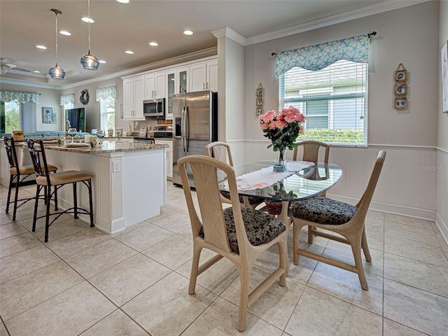 25784 Grayton Ave, Englewood, FL 34223 - dining room featuring ornamental molding, wainscoting, recessed lighting, and light tile patterned floors