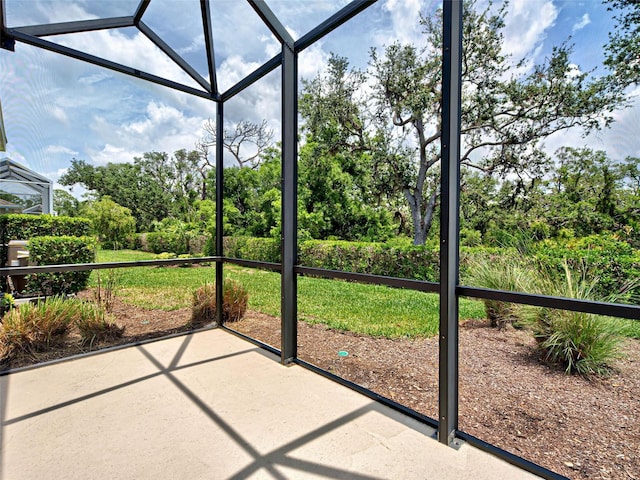 25784 Grayton Ave, Englewood, FL 34223 - unfurnished sunroom featuring view of wooded area